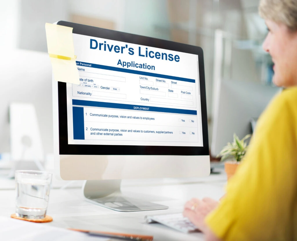 Woman checking status of driving license online - how do you know if your license is suspended 