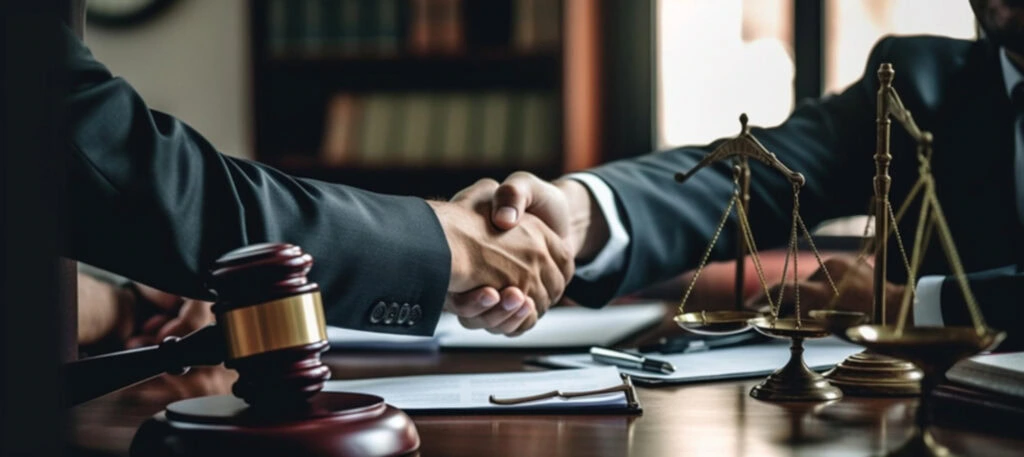 lawyer and the client shaking hands- what should i do if i have an active warrant? 